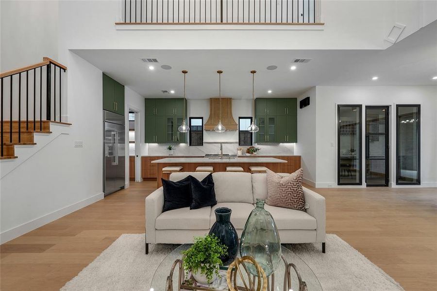 Living room with light wood-style flooring and recessed lighting Living room with light wood-style flooring and recessed lighting