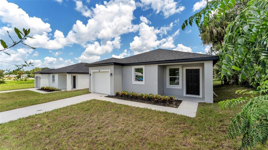 Front exterior of a new home in , Haines City, FL, highlighting curb appeal (Image 2). Front exterior of a new home in , Haines City, FL, highlighting curb appeal (Image 2).