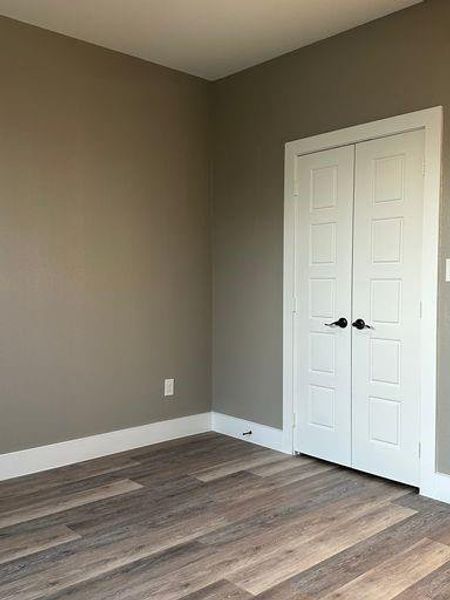 Unfurnished bedroom featuring a closet and hardwood / wood-style flooring