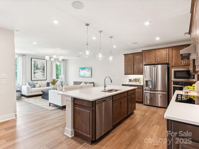 Central island anchoring the kitchen and providing the perfect space for casual dining. *Model Photos | Actual finishes, structural selections, and orientation may vary.