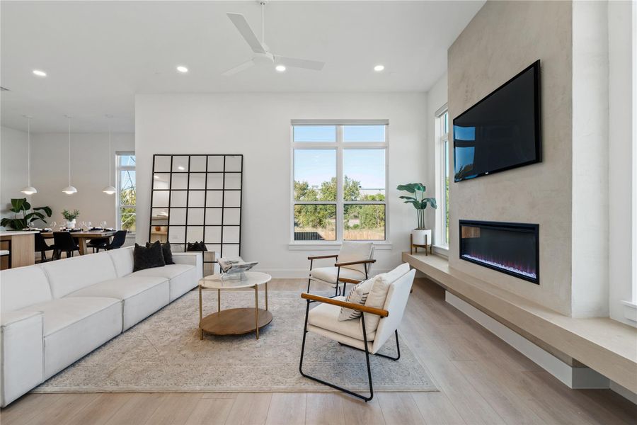 Anchored by a linear fireplace and expansive window placement, this living area is designed around balance and scale, allowing natural light and architectural symmetry to define the space.