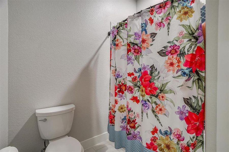 Bathroom with tile patterned floors and toilet