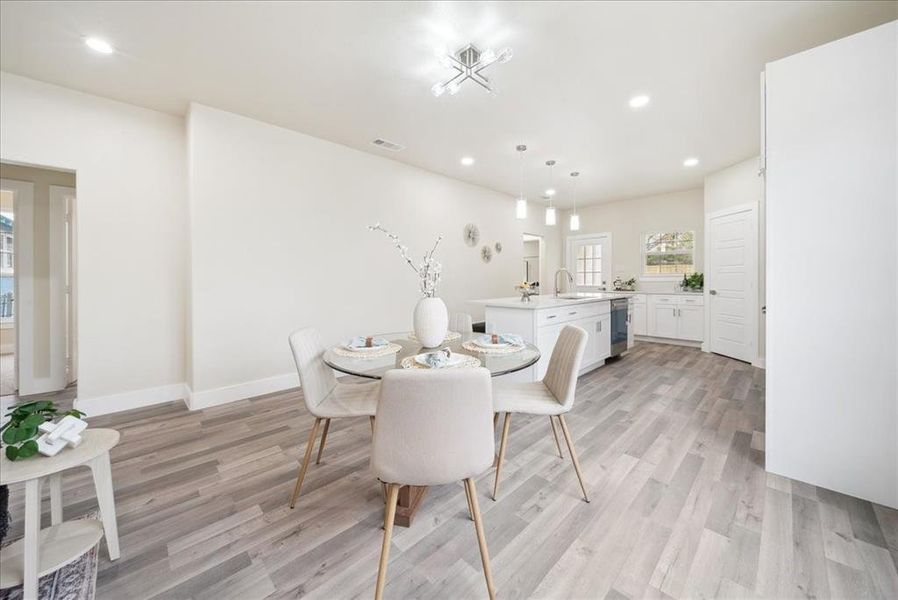 Dining space featuring light hardwood / wood-style flooring and sink