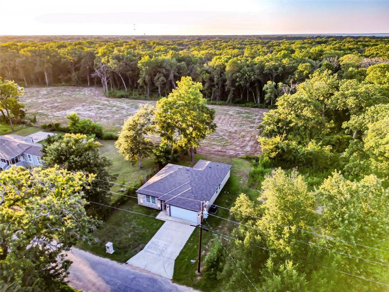 Aerial view of property and surrounding area with a heavily wooded area Aerial view of property and surrounding area with a heavily wooded area