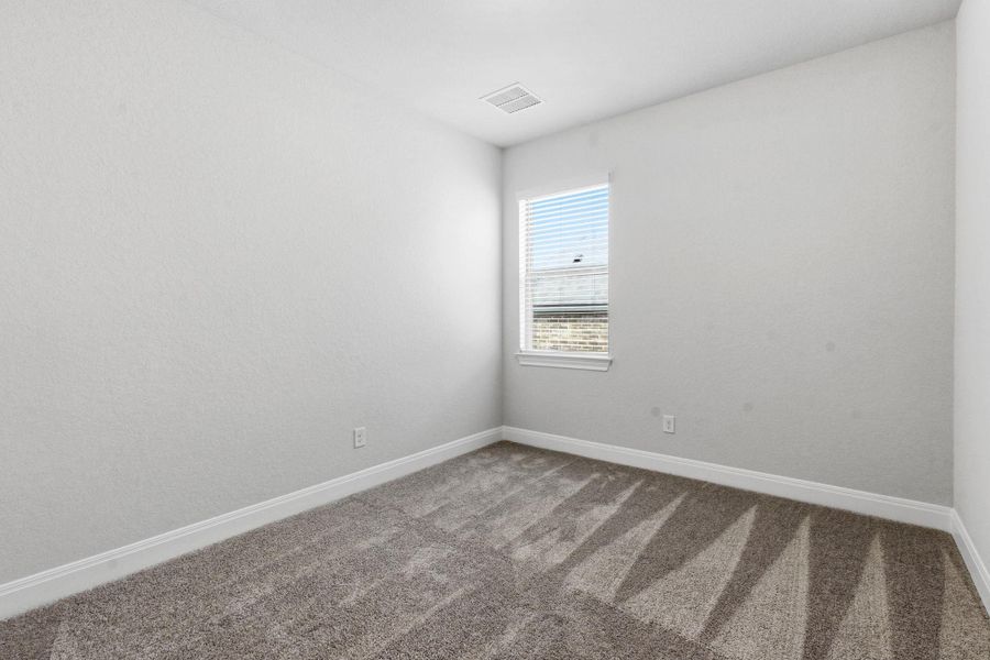 Carpeted spare room with baseboards
