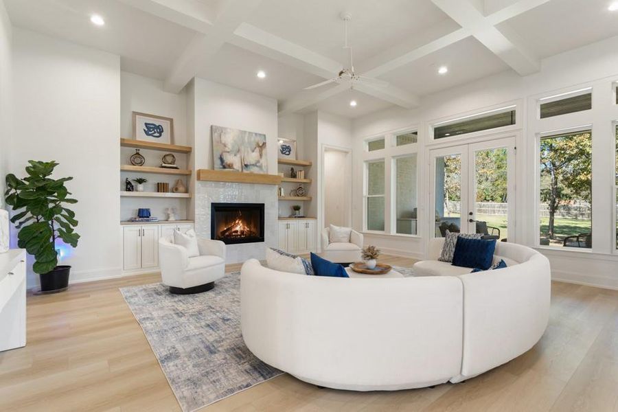 Living room featuring recessed lighting, a tiled fireplace, beam ceiling, light wood-style floors, and coffered ceiling