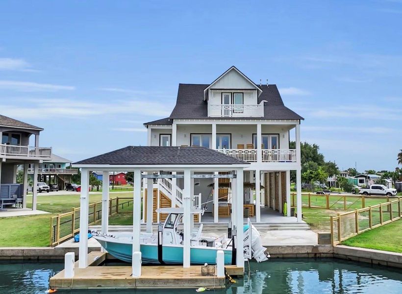 View from the water of the house and boat lift. (BOAT NOT INCLUDED)