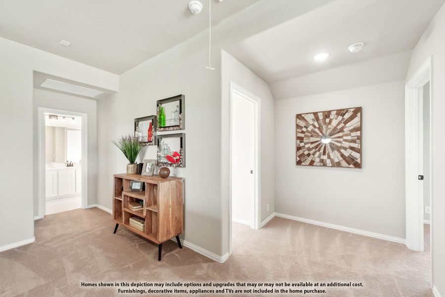 Hallway or flex room with carpet, wood shelving unit, wall art, and view into bathroom Hallway or flex room with carpet, wood shelving unit, wall art, and view into bathroom