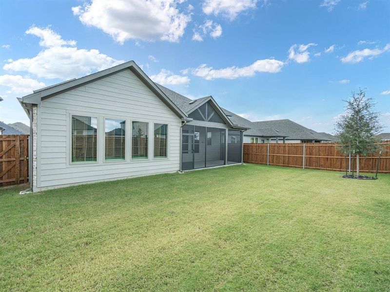 Back of house with a sunroom and a fenced backyard