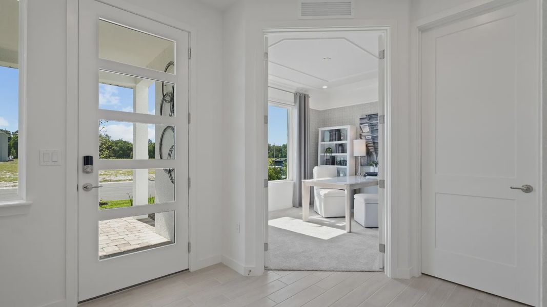 Front entry and adjacent private study at a DRB Homes Ambersweet model at the Trinity Place community. Front entry and adjacent private study at a DRB Homes Ambersweet model at the Trinity Place community.