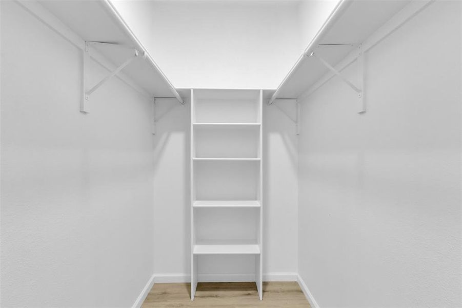 Walk in closet featuring light wood-type flooring