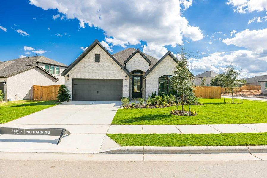 French provincial home with stone siding, concrete driveway, and an attached garage French provincial home with stone siding, concrete driveway, and an attached garage