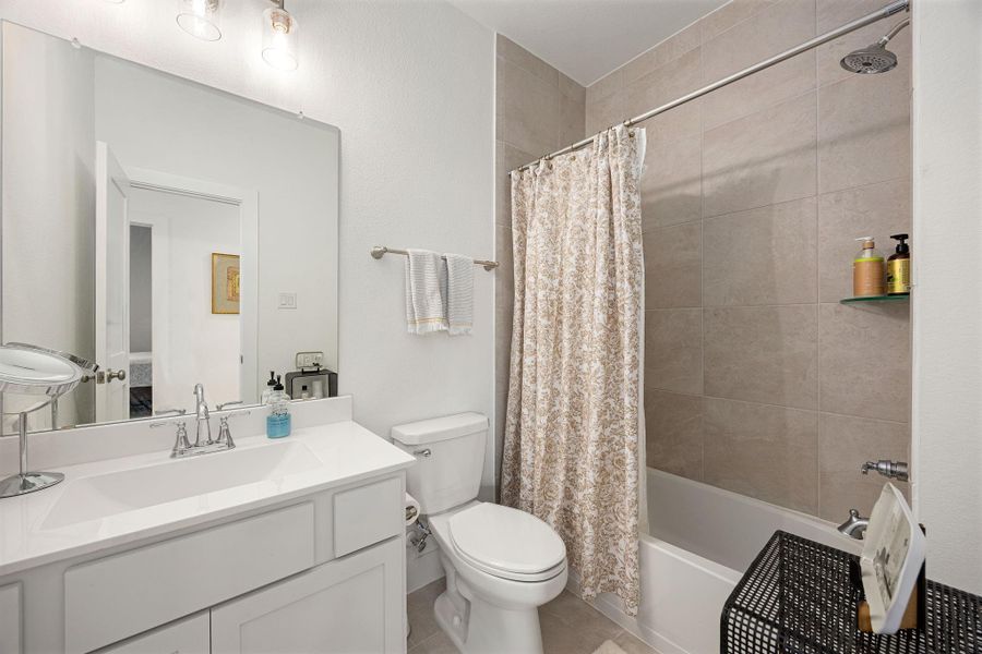 Full bathroom located on the first floor near the two secondary bedrooms