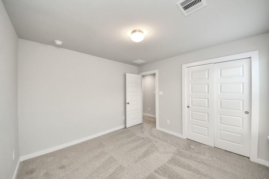 Generously sized secondary bedrooms featuring spacious closets, soft and inviting carpeting underfoot, large windows allowing plenty of natural light, and the added touch of privacy blinds for your personal retreat. Sample photo of completed home with similar floor plan. Actual colors and selections may vary. Generously sized secondary bedrooms featuring spacious closets, soft and inviting carpeting underfoot, large windows allowing plenty of natural light, and the added touch of privacy blinds for your personal retreat. Sample photo of completed home with similar floor plan. Actual colors and selections may vary.