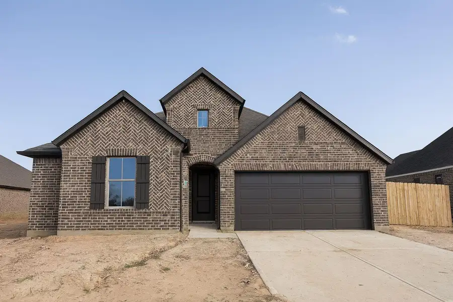 Front exterior of a new home in Escondido, Magnolia, TX, highlighting curb appeal (Image 1).