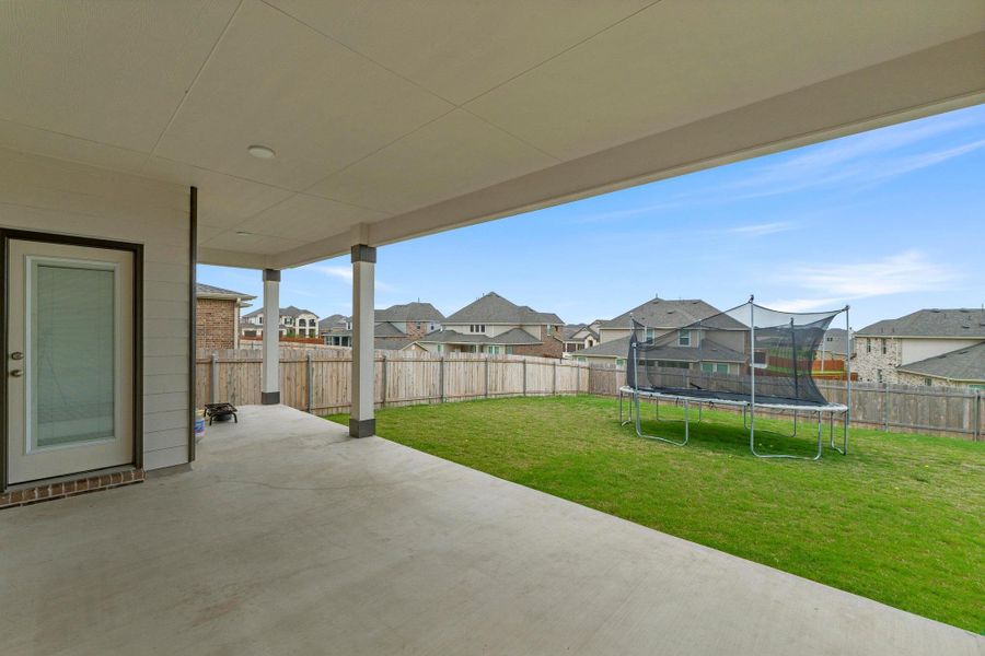 Spacious covered patio with concrete flooring