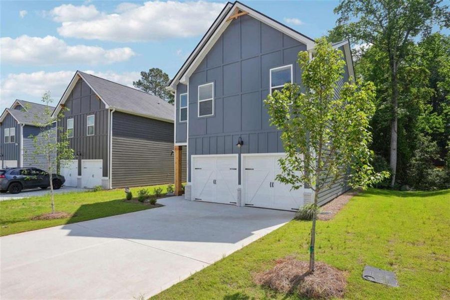 Front exterior of a new home in Campground Crossing, McDonough, GA, highlighting curb appeal (Image 1). Front exterior of a new home in Campground Crossing, McDonough, GA, highlighting curb appeal (Image 1).