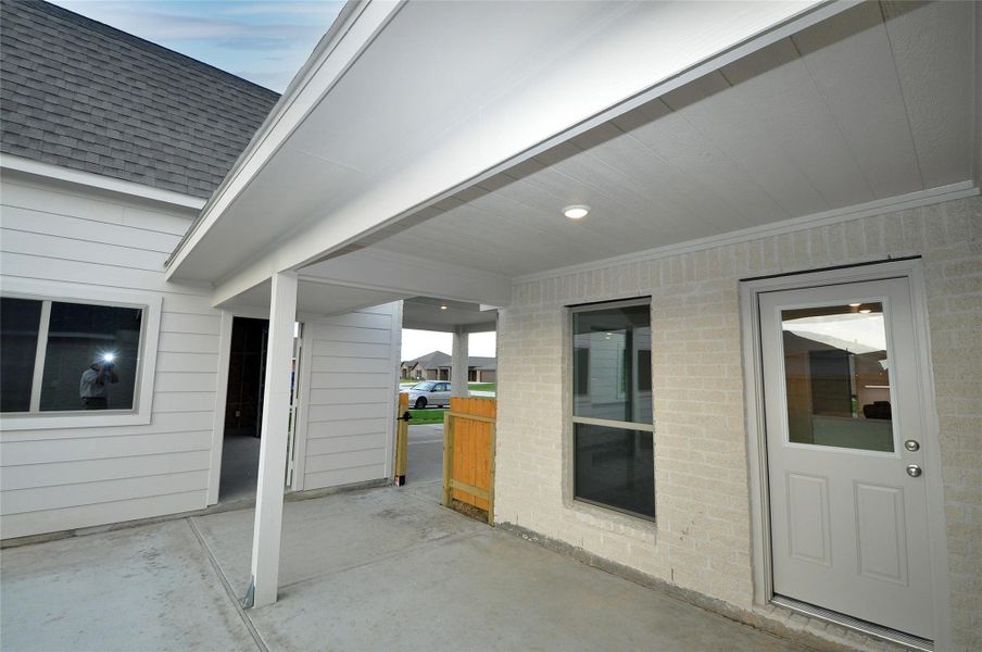 Covered Patio off rear door with breezeway to the garage.