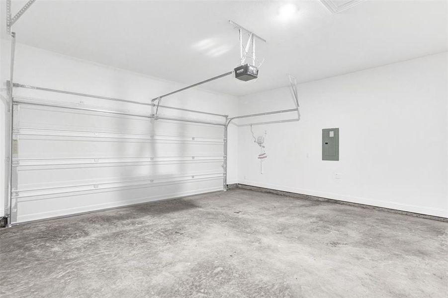 Garage with electric panel and a garage door opener