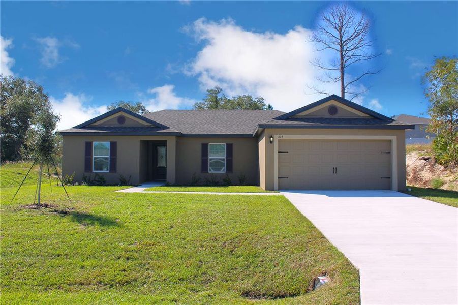 Front exterior of a new home in Poinciana, Poinciana, FL, highlighting curb appeal (Image 1).