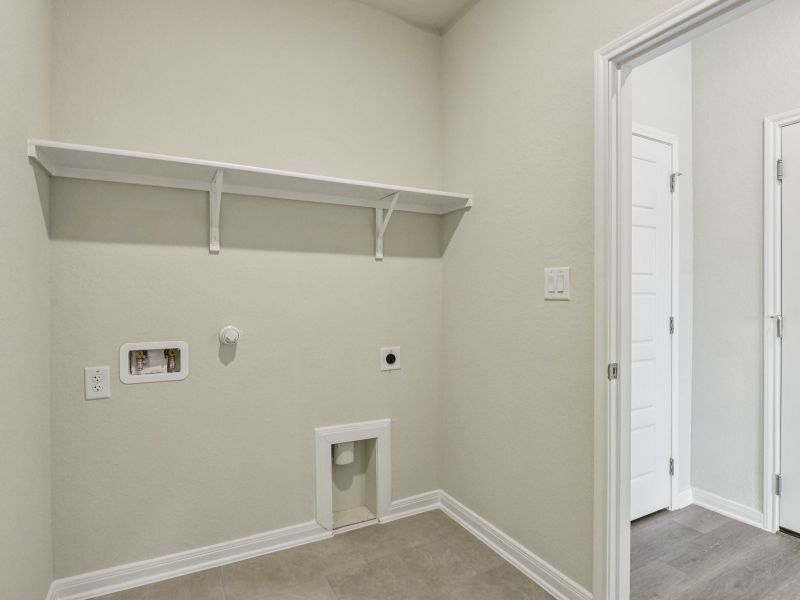 Laundry room in the Oleander floorplan at a Meritage Homes community.