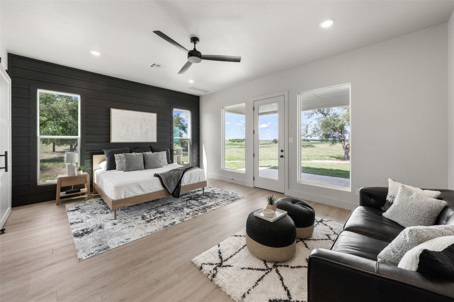 Bedroom with multiple windows, access to outside, recessed lighting, light wood-style floors, and ceiling fan Bedroom with multiple windows, access to outside, recessed lighting, light wood-style floors, and ceiling fan