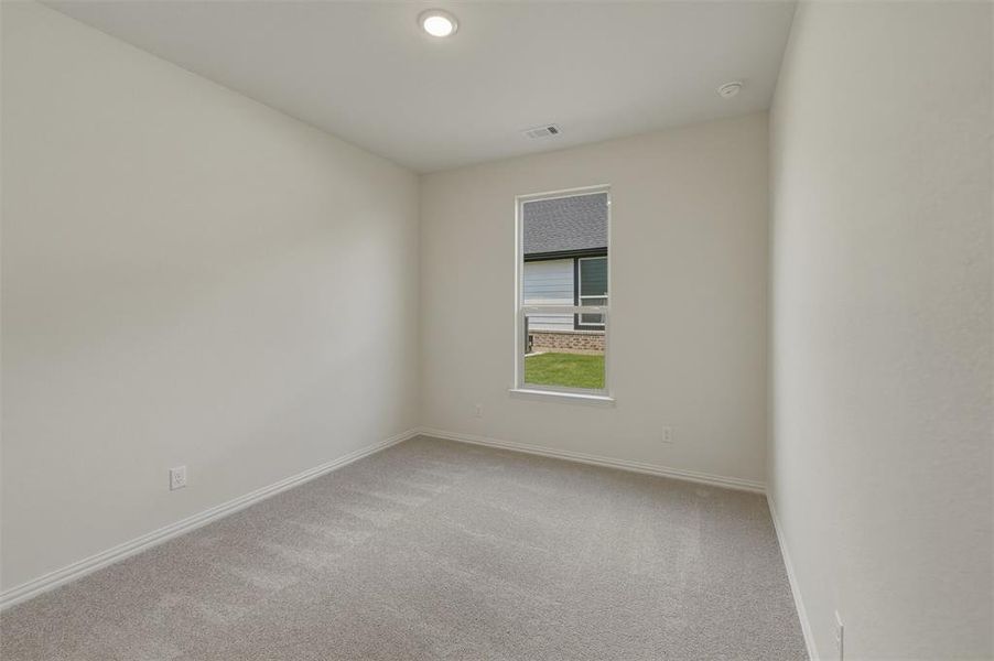 Neutral painted walls featuring a single window and recessed lighting