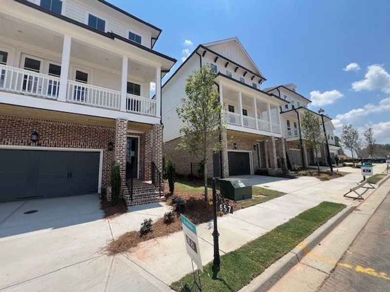 Front exterior of a new home in Palisades Single Family, Cumming, GA, highlighting curb appeal (Image 31).
