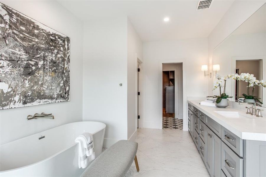 Bathroom featuring vanity and a tub