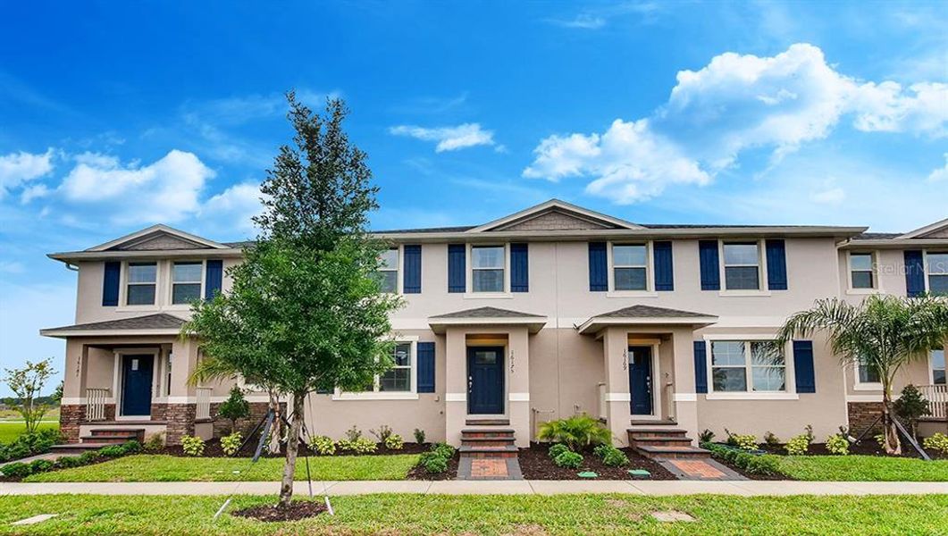Front exterior of a new home in Waterleigh, Winter Garden, FL, highlighting curb appeal (Image 1). Front exterior of a new home in Waterleigh, Winter Garden, FL, highlighting curb appeal (Image 1).