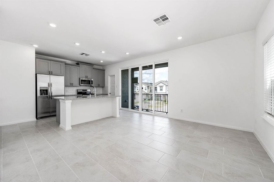 Spacious open-concept 2nd floor living area and kitchen. Note the expansive layout designed for everyday comfort or hosting. Spacious open-concept 2nd floor living area and kitchen. Note the expansive layout designed for everyday comfort or hosting.