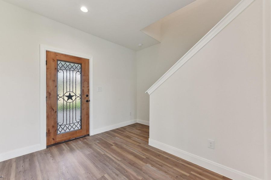 Entryway featuring wood style floors, baseboards, and recessed lighting