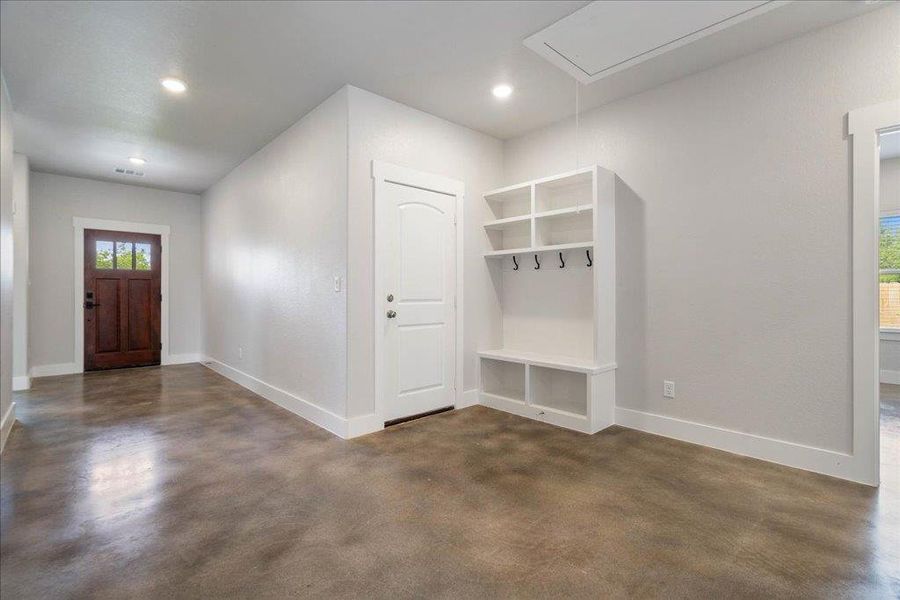 A look at the built-in storage unit off the hallway, providing coat racks, show storage, bench seating, and overhead shelf storage. A look at the built-in storage unit off the hallway, providing coat racks, show storage, bench seating, and overhead shelf storage.