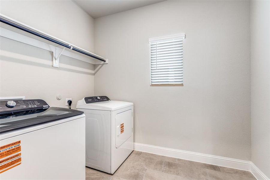 Washroom with baseboards and washer and dryer Washroom with baseboards and washer and dryer