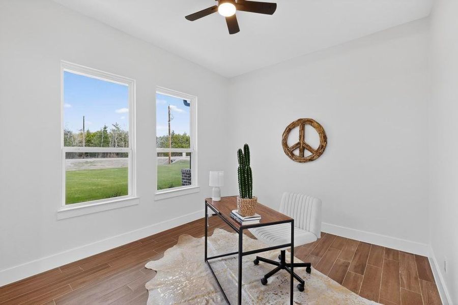 Home office featuring wood finish floors and a ceiling fan Home office featuring wood finish floors and a ceiling fan