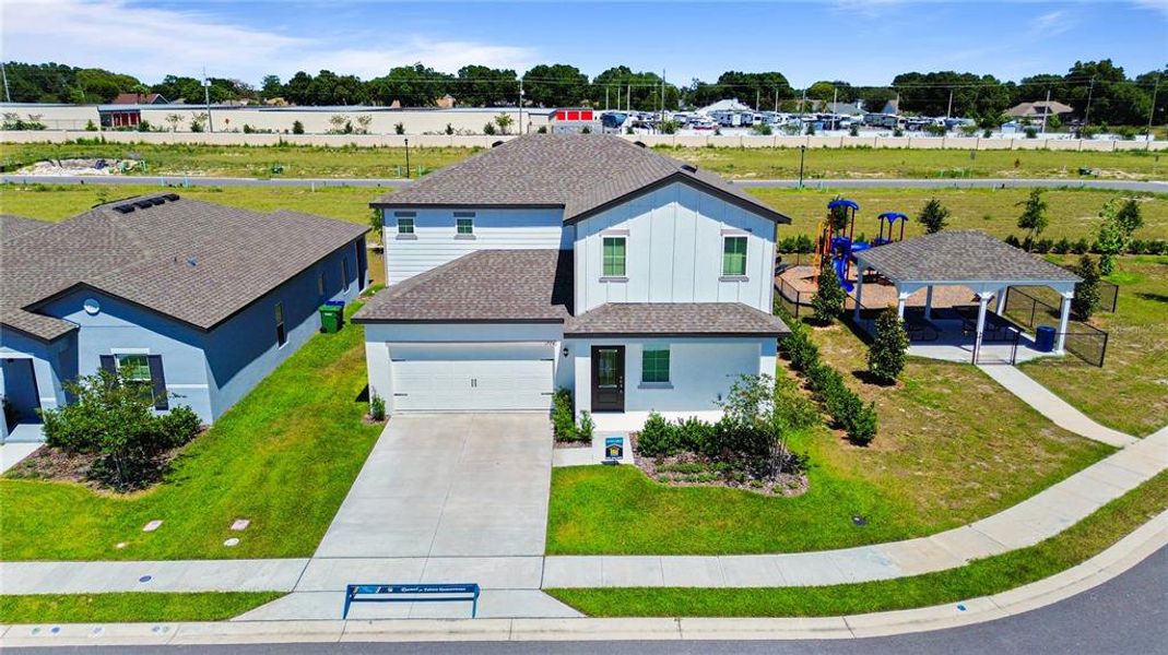 Front exterior of a new home in Peach Crossings, Winter Haven, FL, highlighting curb appeal (Image 13).