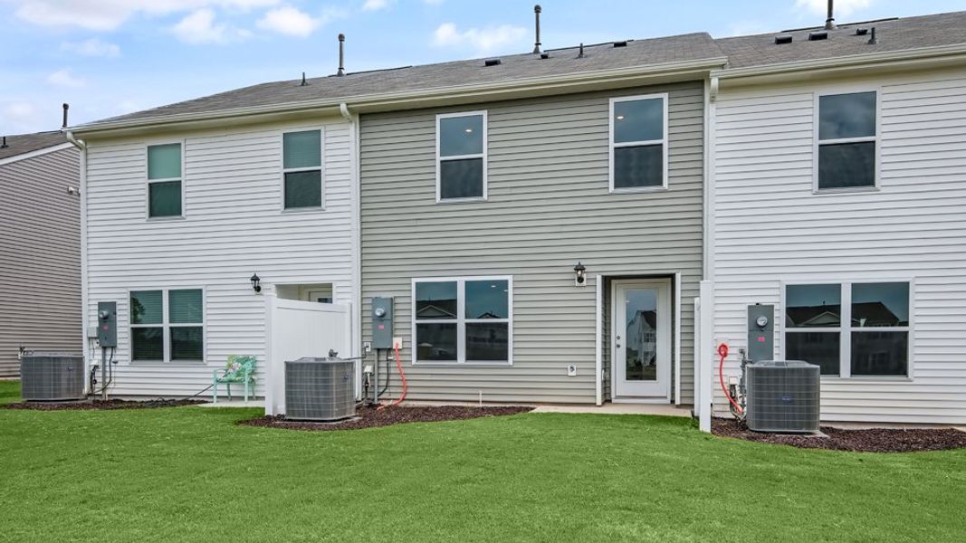 Exterior details and patio area of a home in The Townes at Hunter Hill, Rocky Mount (Image 26).