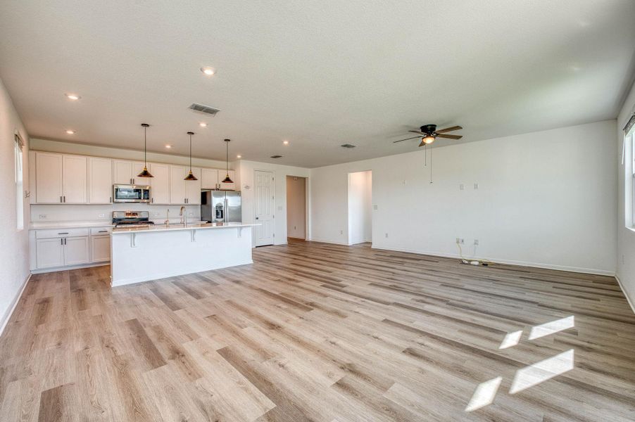 An open concept floor plan seamlessly connects the kitchen to a spacious living area.