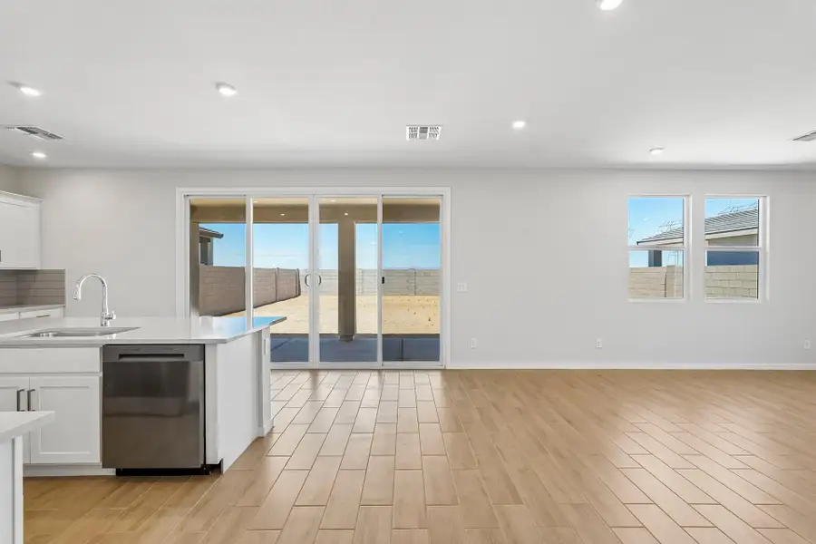 A kitchen with a wood floor.