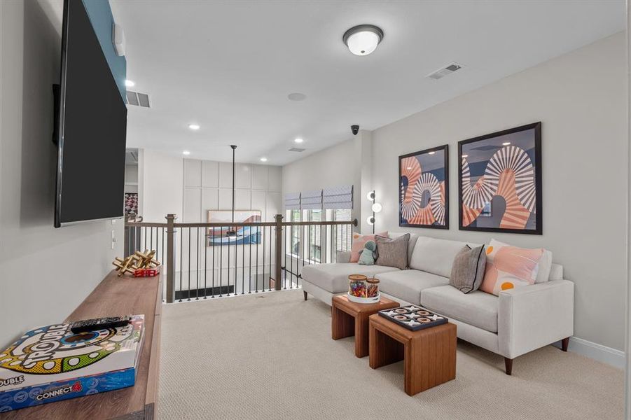 Carpeted living area featuring recessed lighting