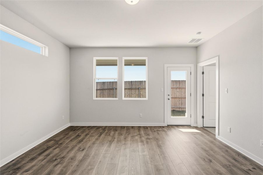 Spare room featuring wood finished floors and baseboards