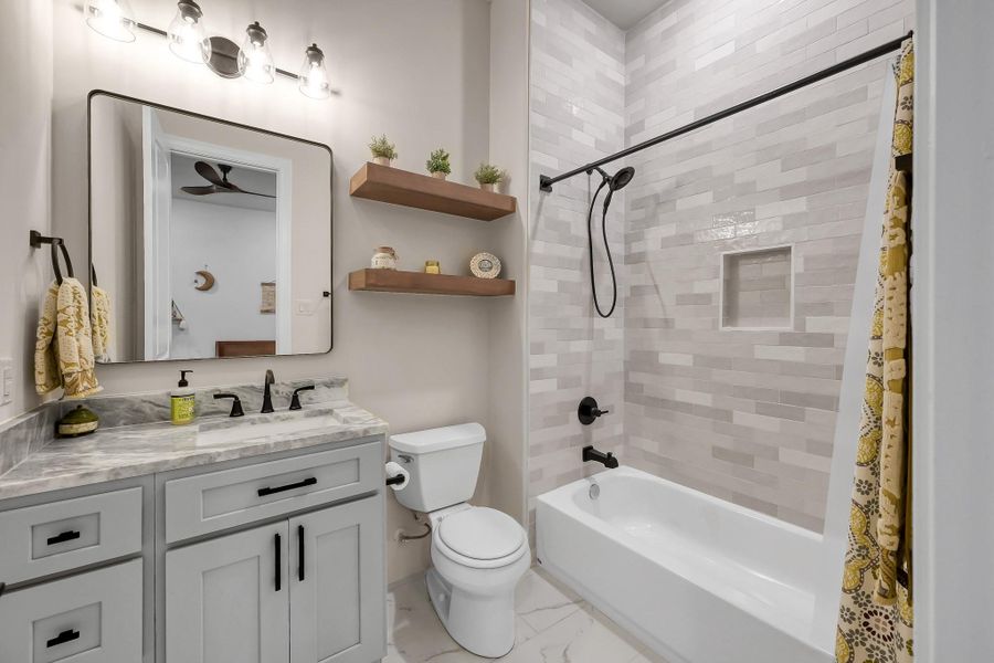 Bright and inviting, this second bedroom features a perfect blend of recessed and natural lighting.