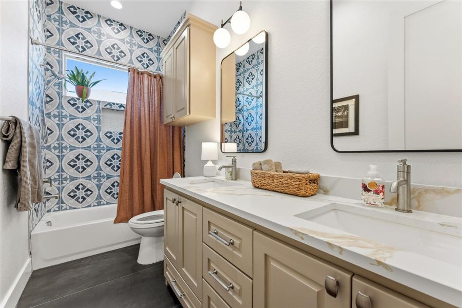 Full bathroom featuring shower / tub combo with curtain and double vanity