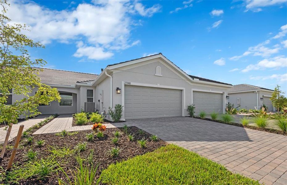 Front exterior of a new home in BeachWalk by Manasota Key, Englewood, FL, highlighting curb appeal (Image 2). Front exterior of a new home in BeachWalk by Manasota Key, Englewood, FL, highlighting curb appeal (Image 2).