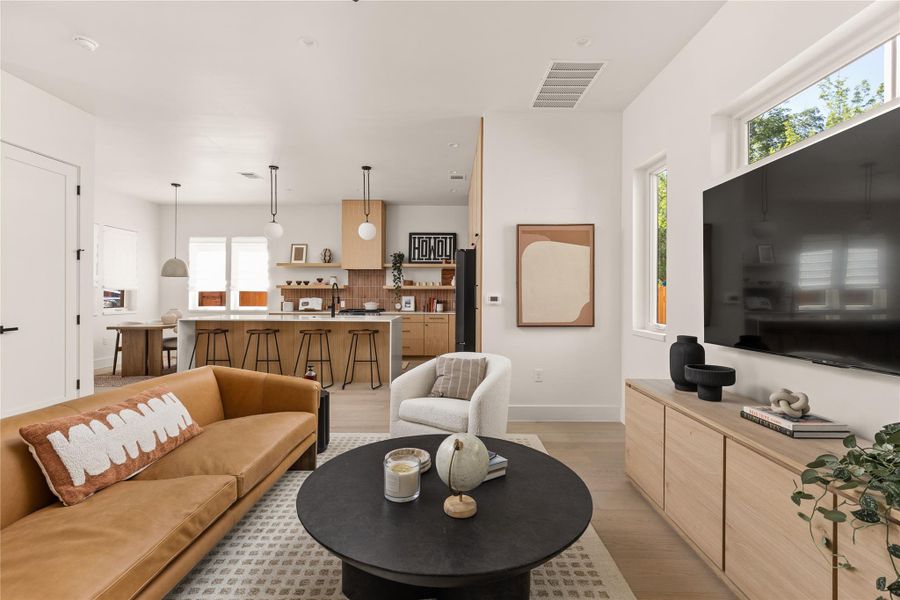 Living room with baseboards and light wood-style flooring