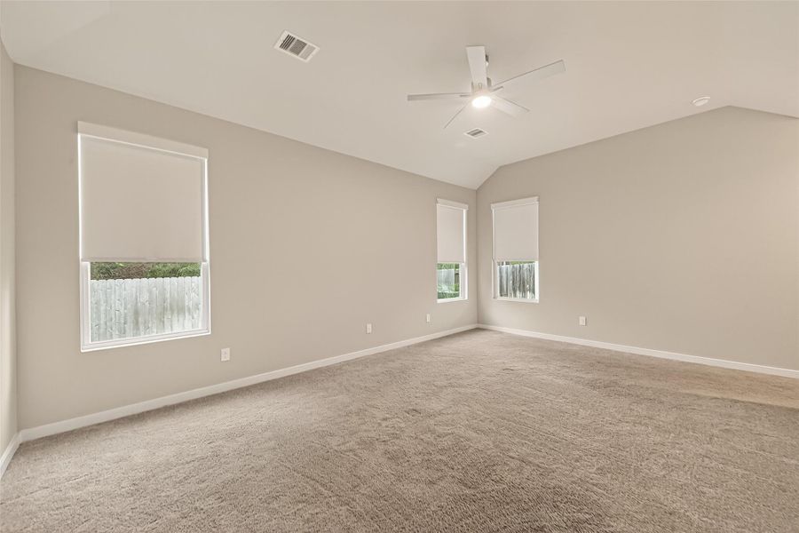 The main bedroom features a high ceiling, creating a more open and airy feel.