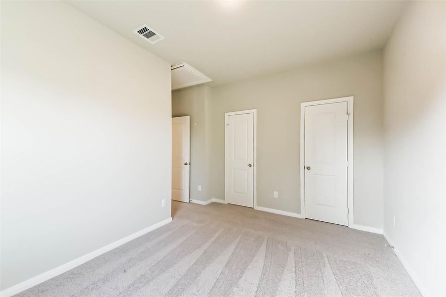The secondary bedroom is situated down the hall, featuring cozy carpeting and ample space to accommodate all your furnishings. The secondary bedroom is situated down the hall, featuring cozy carpeting and ample space to accommodate all your furnishings.