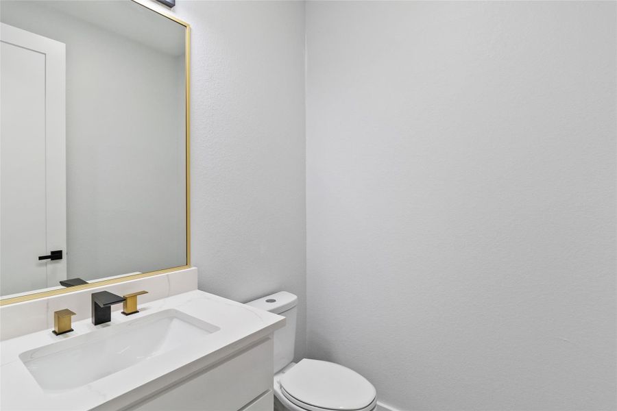 Half bath with vanity and toilet