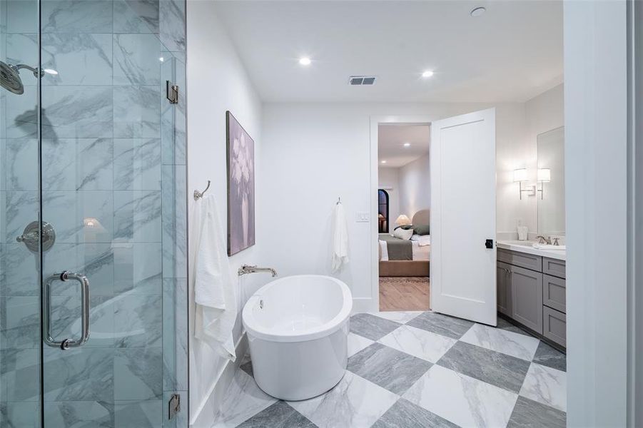 Bathroom with vanity and separate shower and tub