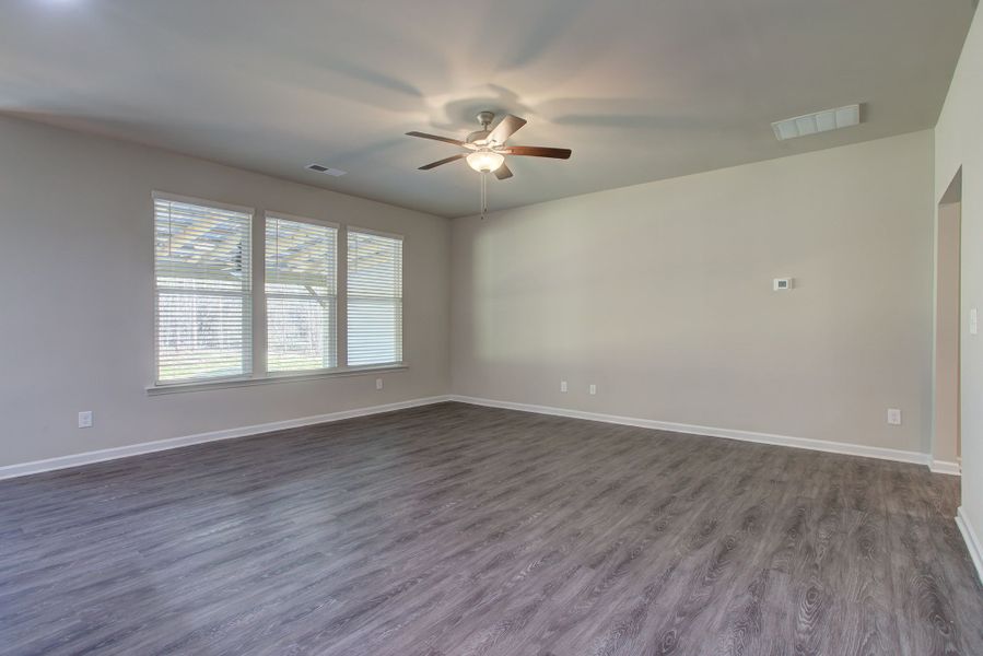 Family room with elevated ceiling height and a wall of windows